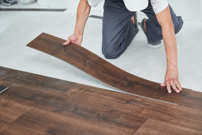 A worker installing vinyl flooring